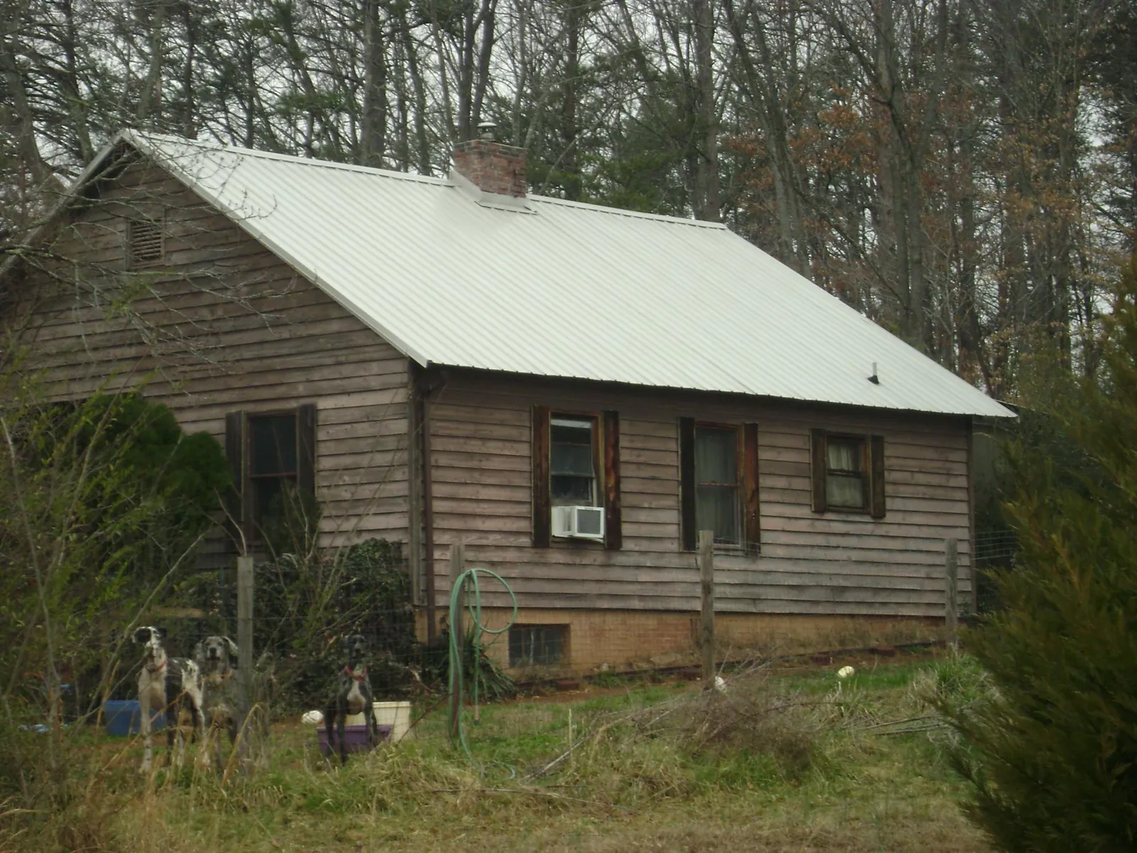 White metal roof on an old wood sided farmhouse, from a Asphalt Shingle Roof Repair job in Woodsboro